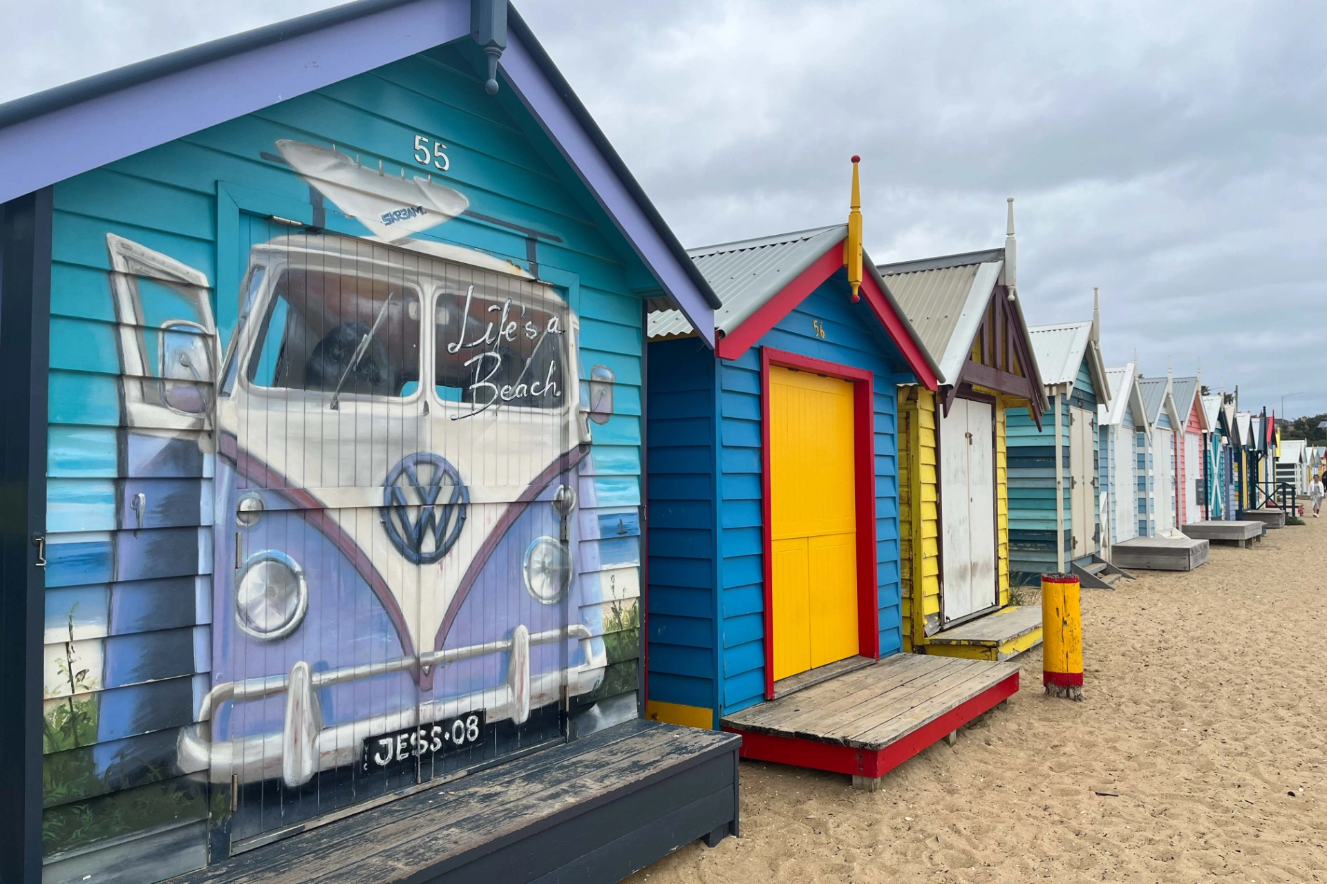 Färgglada strandstugor längs Brighton Beach