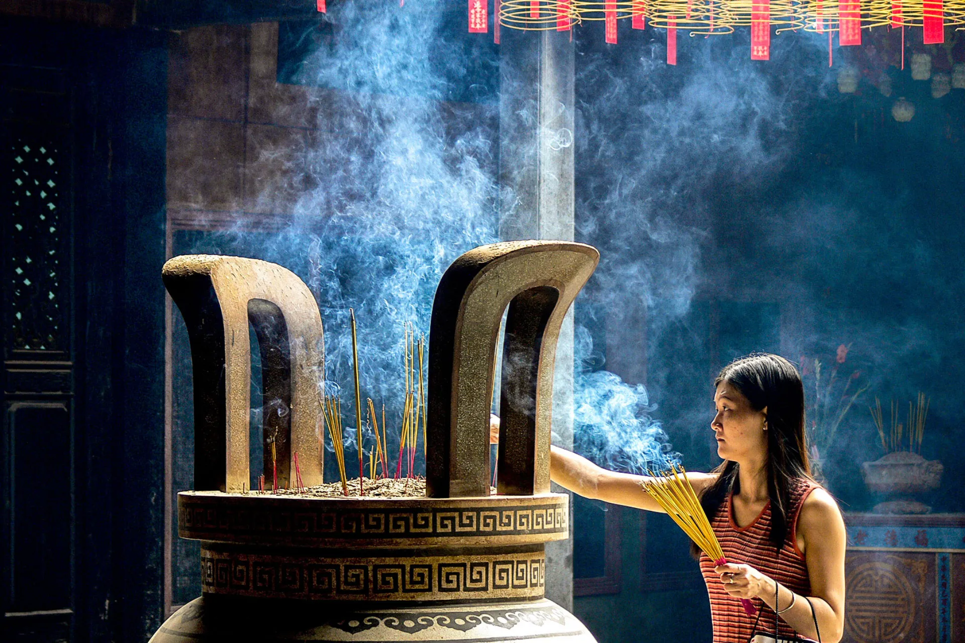 Kvinna med rökelsepinnar i Thien Hau-templet Kvinna med rökelsepinnar i Thien Hau-templet