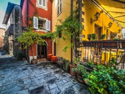 Mysig gränd i Montecatini Alto med färgglada hus och växter Mysig gränd i Montecatini Alto med färgglada hus och växter