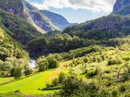 Tåget går längs brusande älvar, fjäll och frodiga dalar